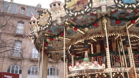 festive traditional carousel spinning around at a festive christmas market in strasbourg, france europe