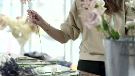 young florist assembles a rustic wedding bouquet