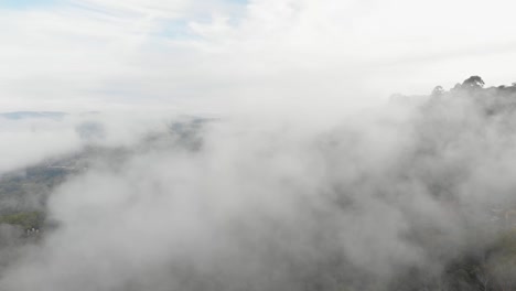 drone view across mist on mountain at morning