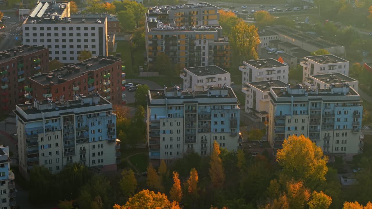 Warsaw, Poland. Aerial View of Sunny Autumn Morning in Residential District, Soft Yellow Light Above Apartment Buildings and Colorful Trees