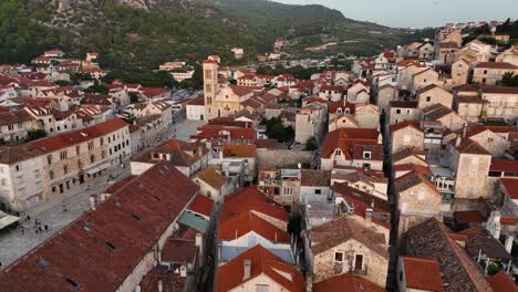 aerial view of the historic city center of hvar with its cathedral and red roofs.