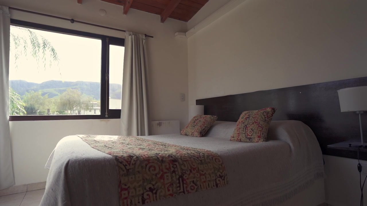 Rustic bedroom with mountain view in luxurious country resort. Hospitality. Business. Argentina.