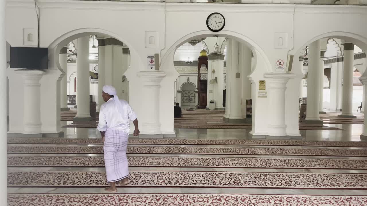 muslim man sit in the The Kapitan Keling Mosque for the prayer