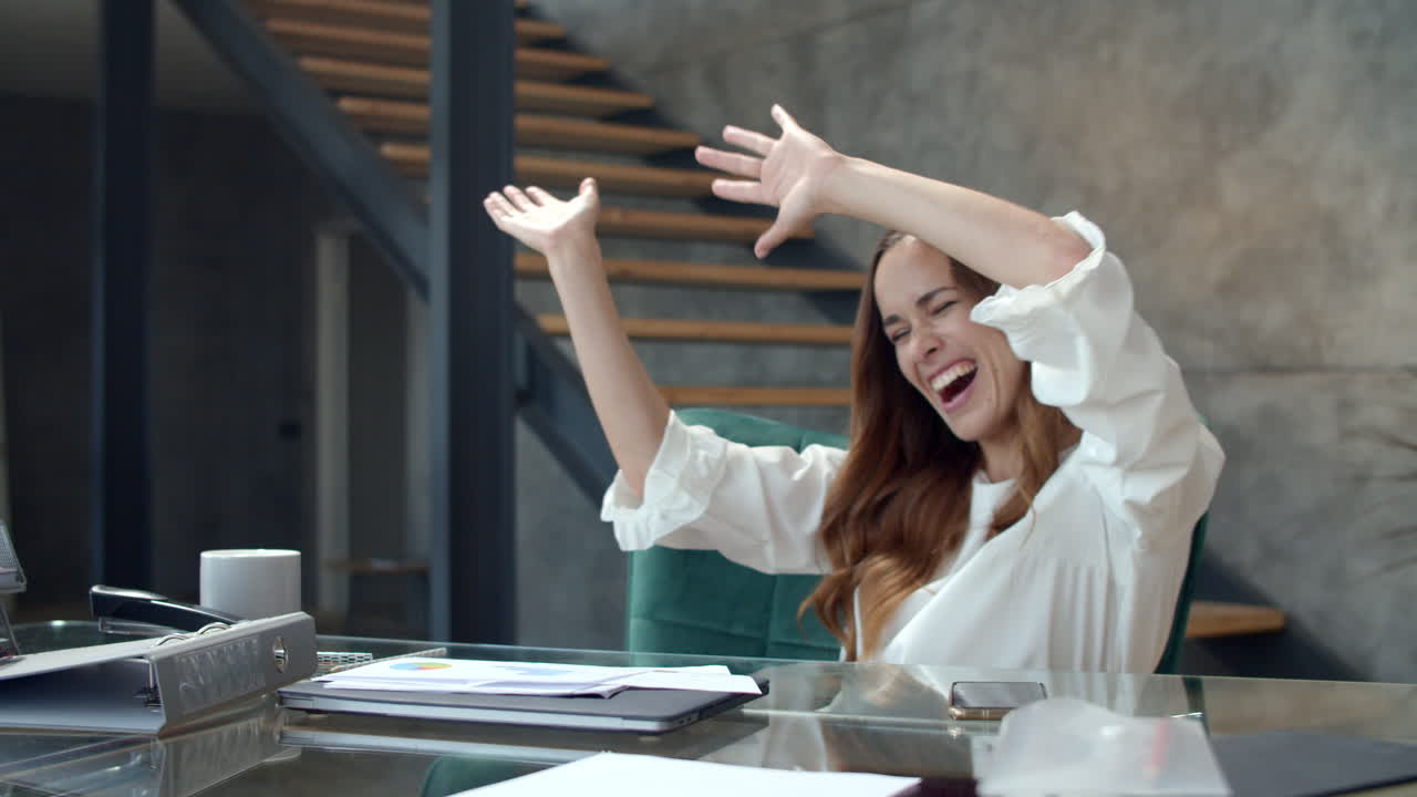 Young business woman getting excited with documents at remote office