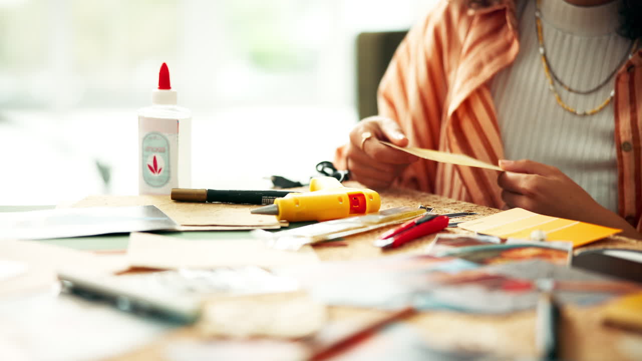 Hands working together on a creative project at a table