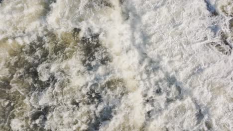 Powerful-waterfall-cascading-over-rocks-in-Owen-Sound,-Canada,-aerial-view