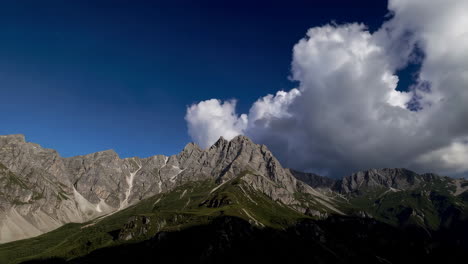 dramatic alpine mountain landscape with changing skies