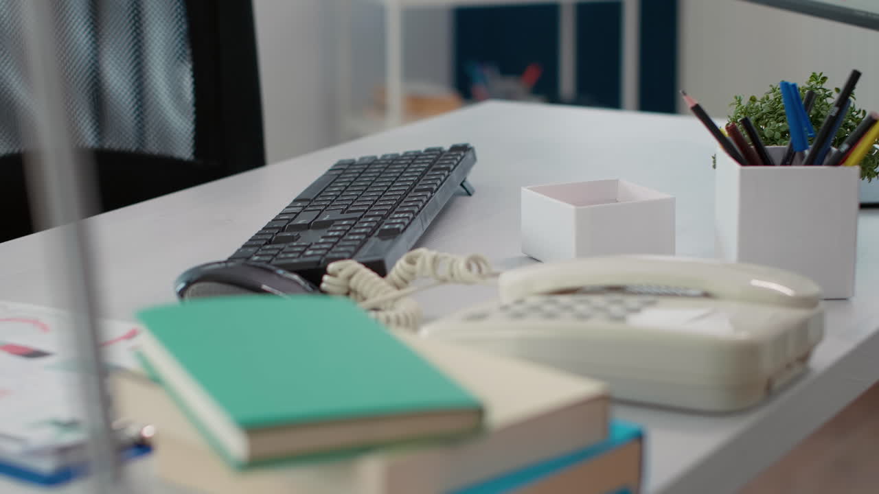 Empty company desk with landline phone and documents