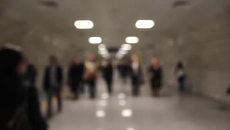 commuter crowd of people walk down the tube underground 1