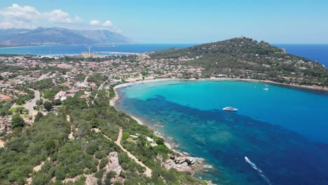 arbatax port town and cove with turquoise blue sea in sardinia, italy - aerial 4k