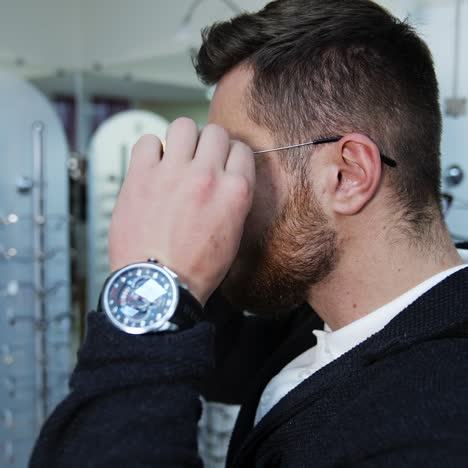 man trying eyeglasses in store
