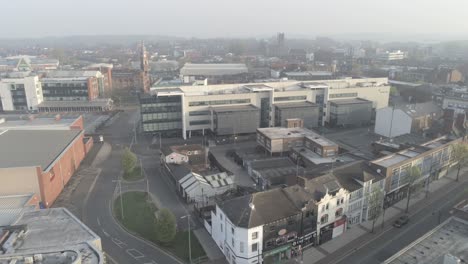 Drone-flying-above-misty-urban-empty-abandoned-COVID-virus-lock-down-town-descending-tilt-up-to-skyline