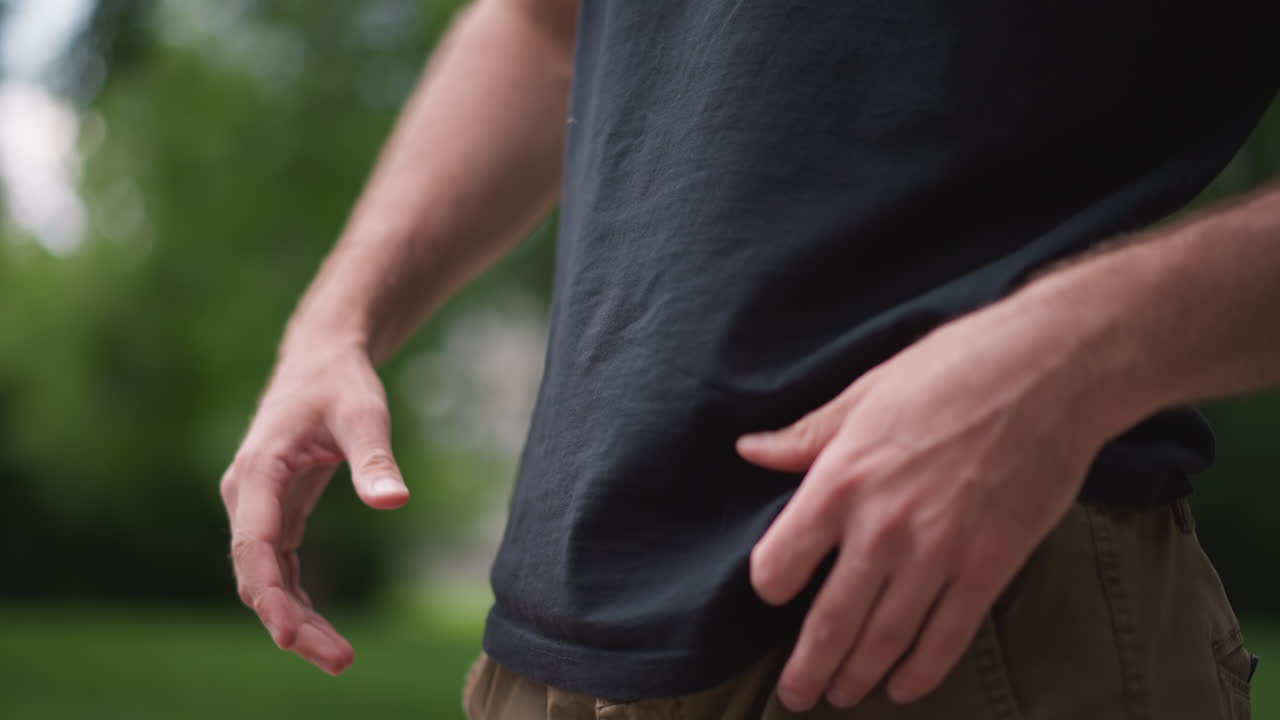 Casual Man Inspects Abdomen Outside, Man In Casual Attire Lifts Shirt Outdoors For Health Check, Individual In Casual Clothing Lifts Shirt Outside To Observe Abdominal Region And Breathe