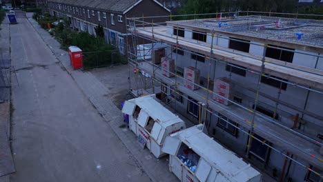 skips and portable loos await morning shift for construction workers