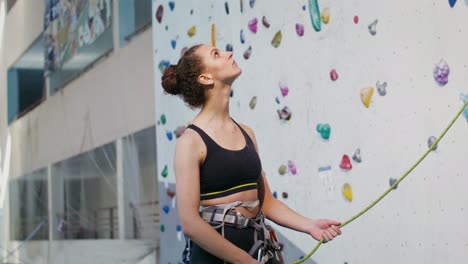 woman rock climbing in indoor gym