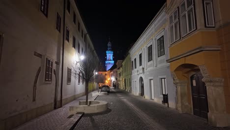 shot of a calm night walk through the streets of old town of sopron, hungary, showcasing the historic architecture.