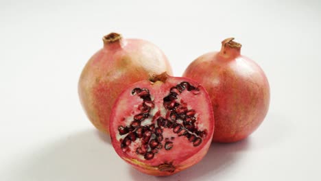 pomegranate with half piece on white background 4k 4k