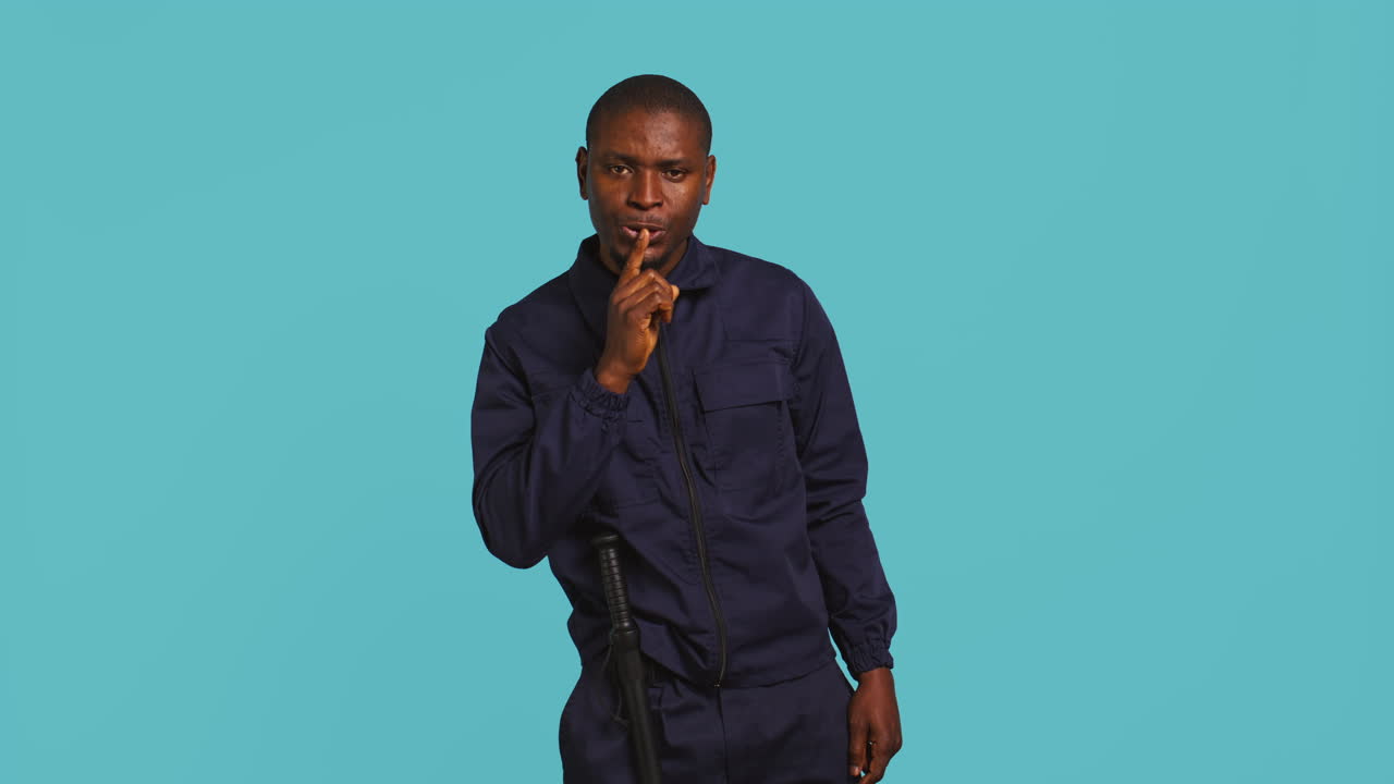 Portrait of security guard doing shush sign gesturing with finger