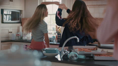 happy teenage girls dancing in kitchen eating pizza having fun celebrating together enjoying hanging out together on weekend