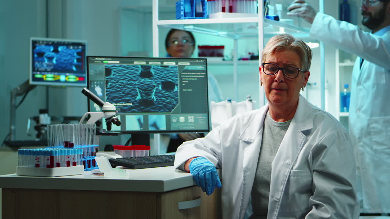 Portrait of old chemist woman with fatigued face in front of camera