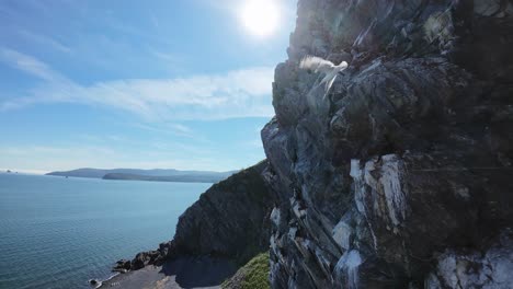 explore a mesmerizing rocky coastline at dawn with vibrant skies and calm waters