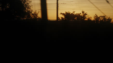 view from a moving train at dawn