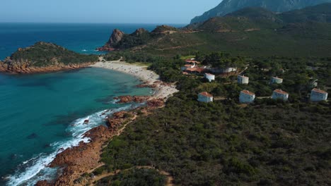 beautiful aerial drone idyllic natural sand beach sandy bay on the tourist vacation island sardinia in italy with sun, clear blue turquoise and calm water close to la maddalena