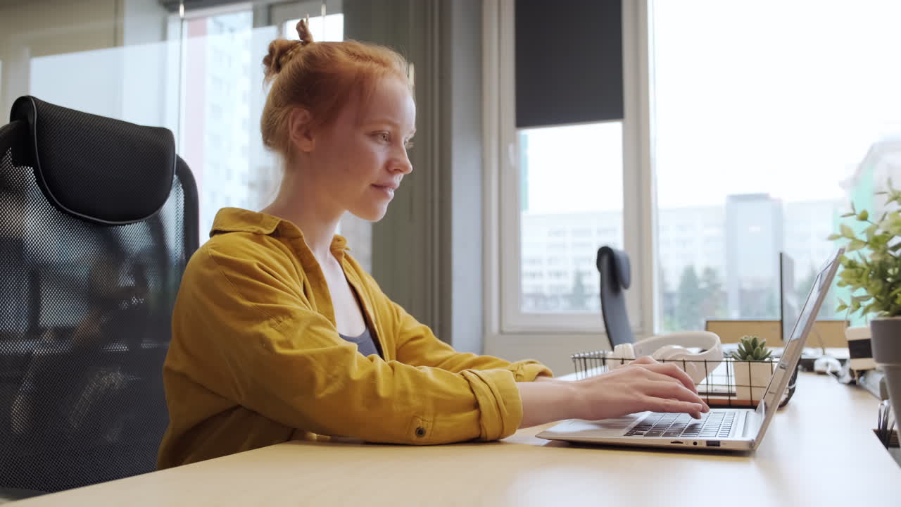 Joyful Office Worker Typing On Laptop