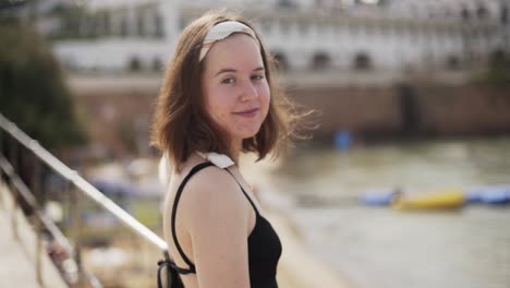 outdoor shot of the beautiful young girl who poses on the bridge in a clear,sunny day