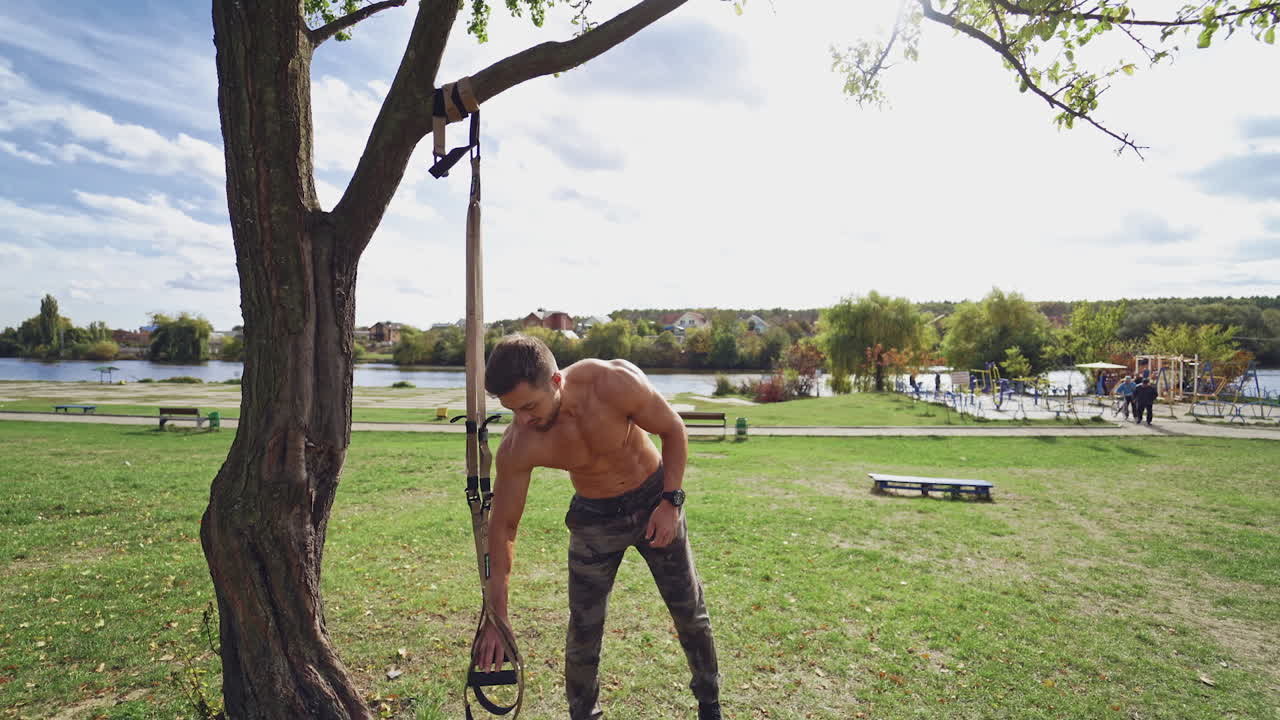 Shirtless male exercise outdoors. Muscular athlete exercising push up outside