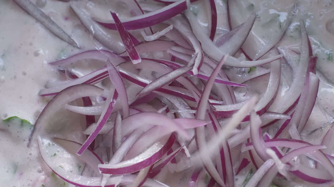 putting onions on the peruvian ceviche