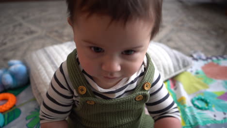 hispanic baby boy playing in living room