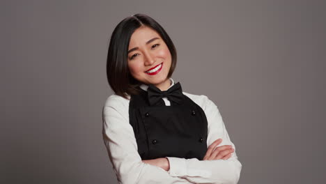 asian restaurant employee serving clients at tables