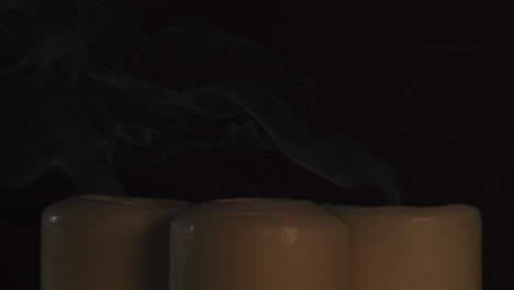 burning candles with smoke