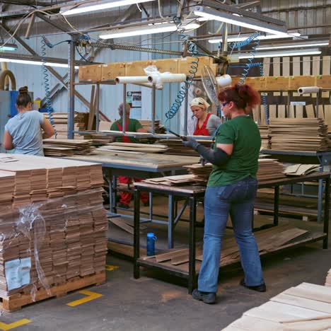 factory for the production of parquet board. workers in the wood industrial factory. interior of furniture factory production.