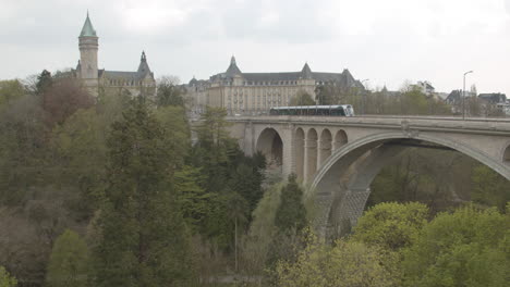 tram driving over adolphe bridge towards the old part of luxembourg city