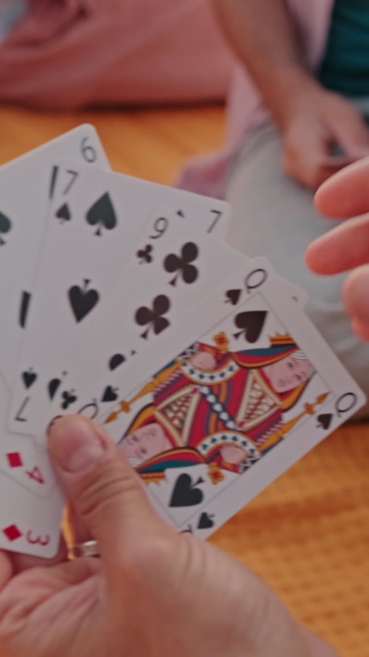 Friends Playing Cards At a Picnic
