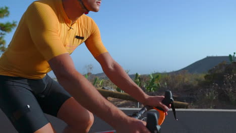 a man rides his road bike on an empty morning road, partaking in outdoor exercise. the slow-motion footage conveys the thrill of extreme sports