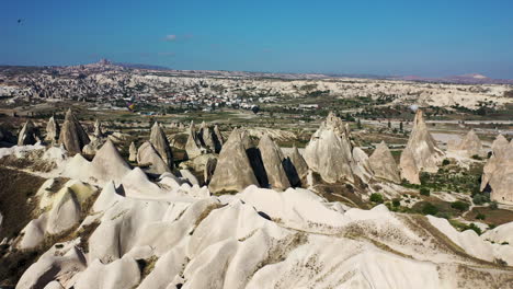 Rotating-revealing-epic-drone-shot-of-the-fairy-chimneys-outside-Cappadocia-and-the-mountain-valley-outside-the-city-in-Turkey