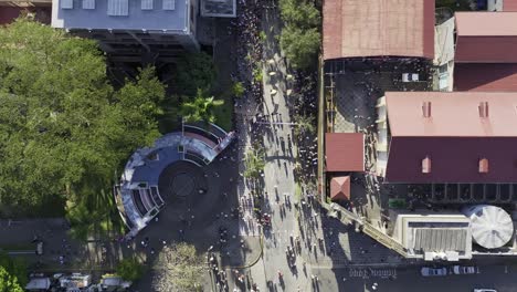 SAN-JOSE,-COSTA-RICA---JUNE-14,-2023:-flag-wavers-and-dancers-parading-on-the-streets-at-the-International-Festival-of-Arts