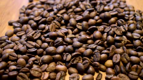 throwing raw coffee beans on a wooden table