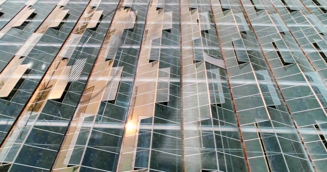 Vertical video: Shifting glare sliding across glass panes with mullions from clouds and cam drift