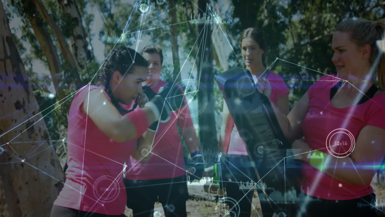 Fitness group members practicing boxing outdoors, showing animated data overlay punch metrics