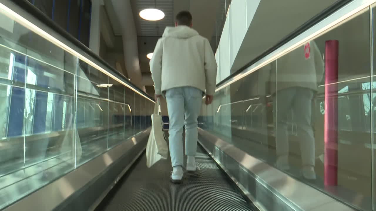 People using an escalator in a shopping mall