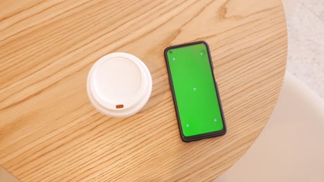 coffee and phone on wooden table