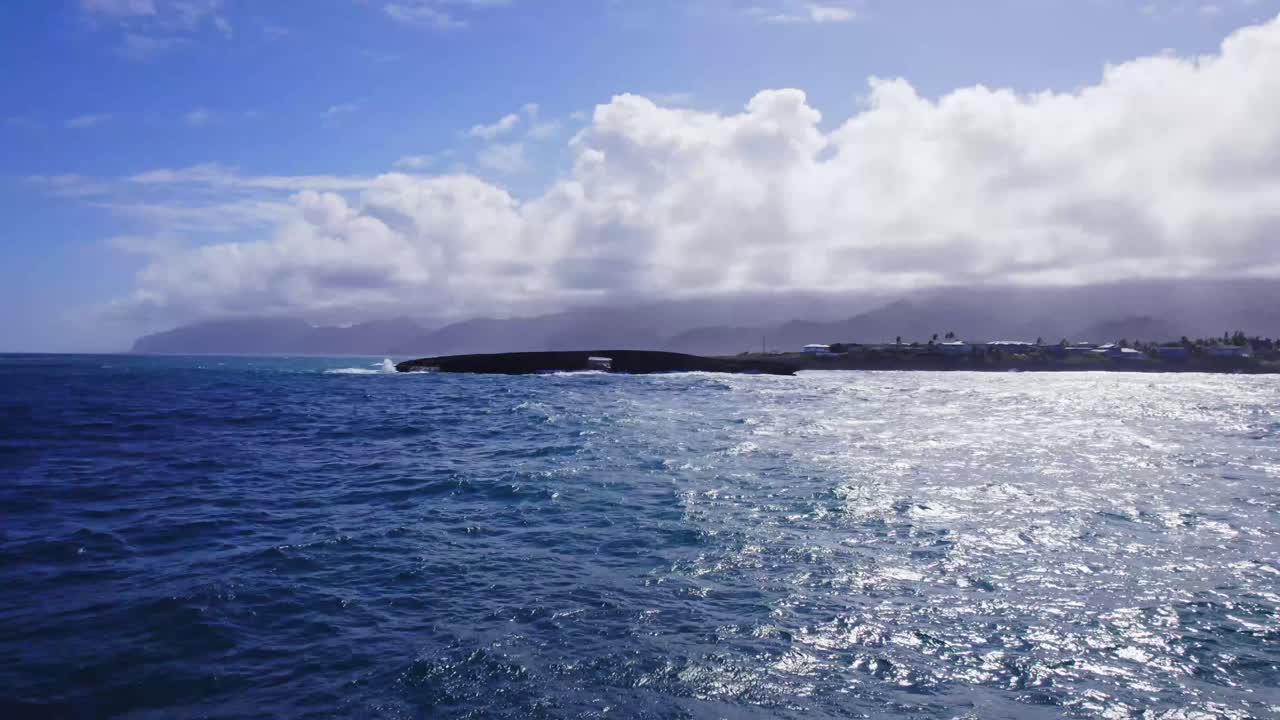 Ocean Waves Crashing on a Rocky Coastline Under a Cloudy Sky