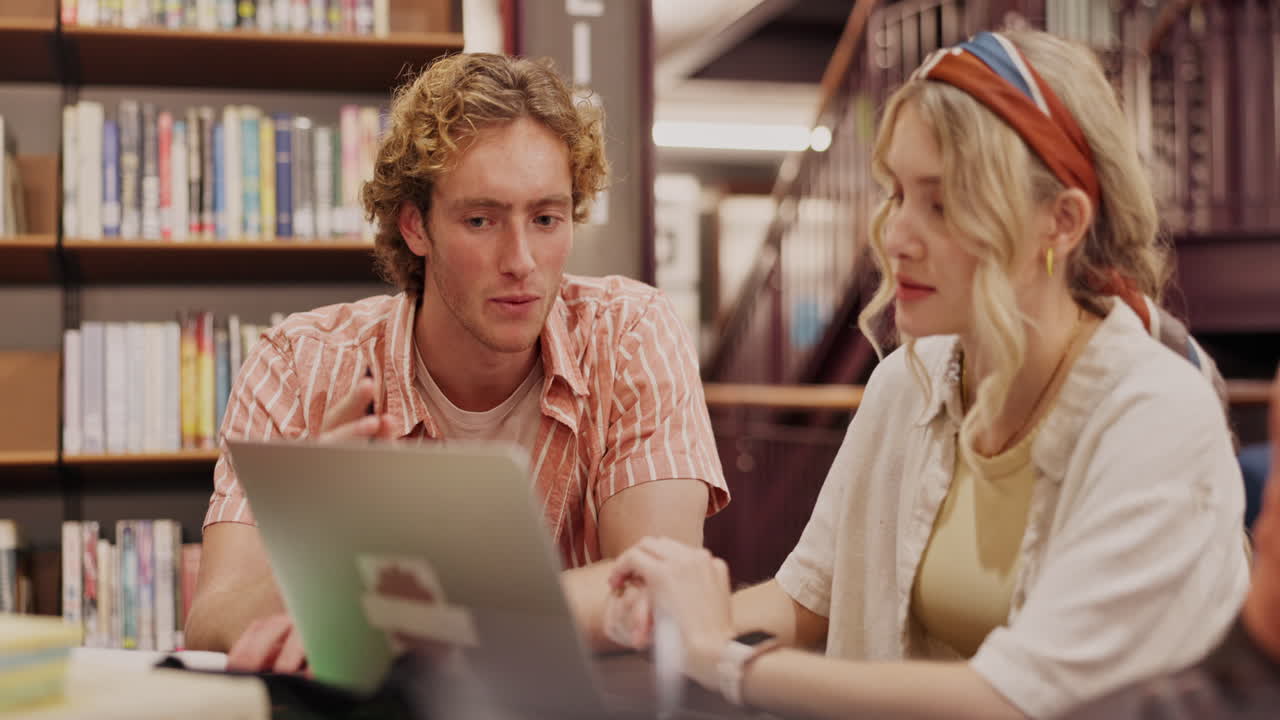 Two students studying in the library