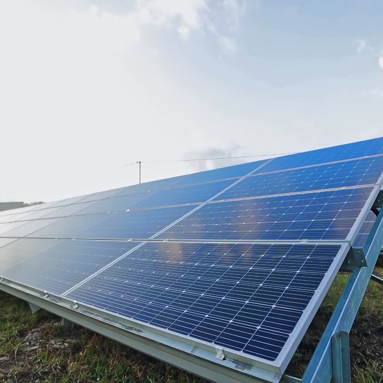 Blue sunny panel at sunlight on the ground. Photovoltaic panel to get clean ecological energy from the sun. Alternative source of energy. Motion camera back.