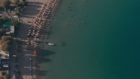 Pan-down-aerial-shot-over-swimmers-in-Lindos