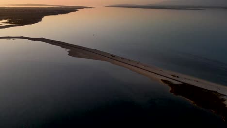 Drone-flight-over-the-sea-Plaza-Ninska-laguna-in-Croatia-city-Nin-at-twilight